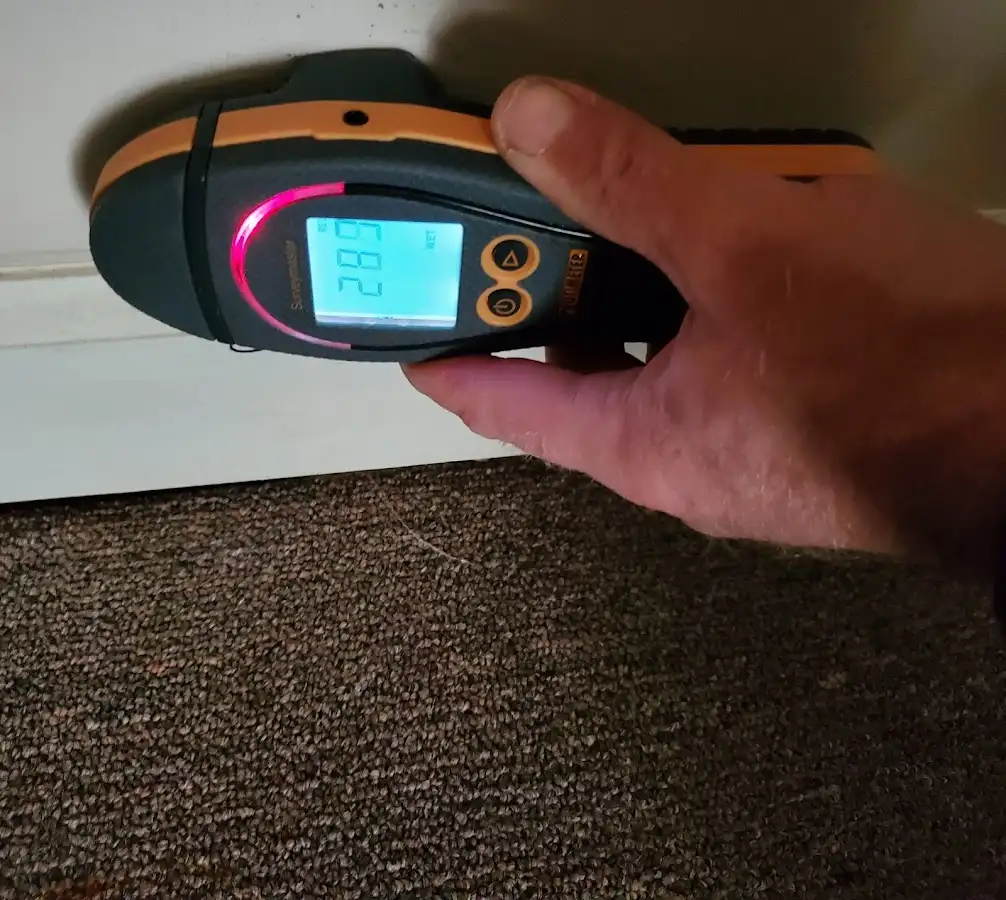 Moisture detection at baseboard during Storm Damage Restoration in Merriam